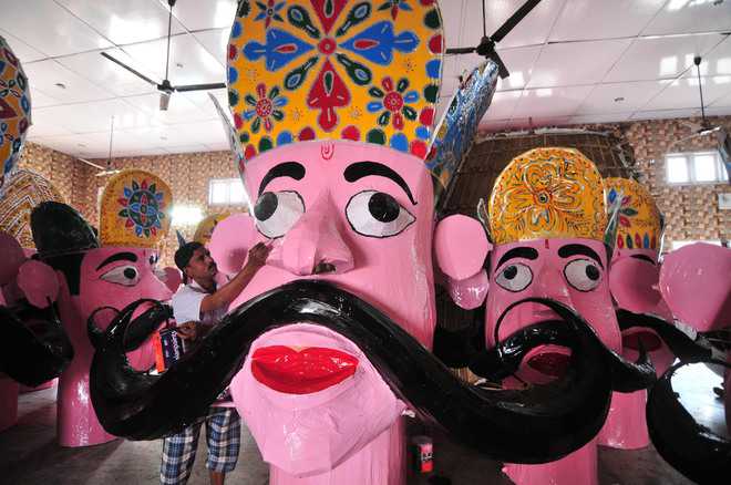 Mohd Gayasuddin gives final touches to an effigyof Ravana in Jammu.