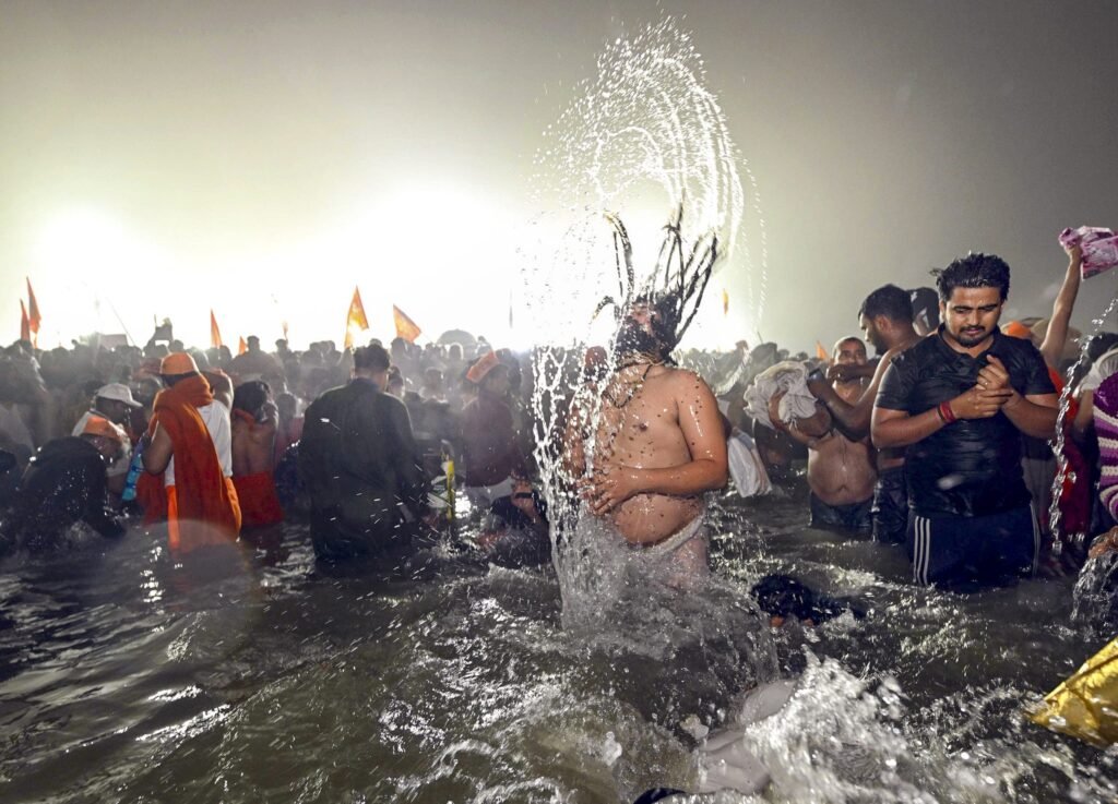 Devotees take a holy dip at the Sangam on the occasion of 'Makar Sankranti' festival, during the Maha Kumbh Mela 2025, in Prayagraj, Uttar Pradesh